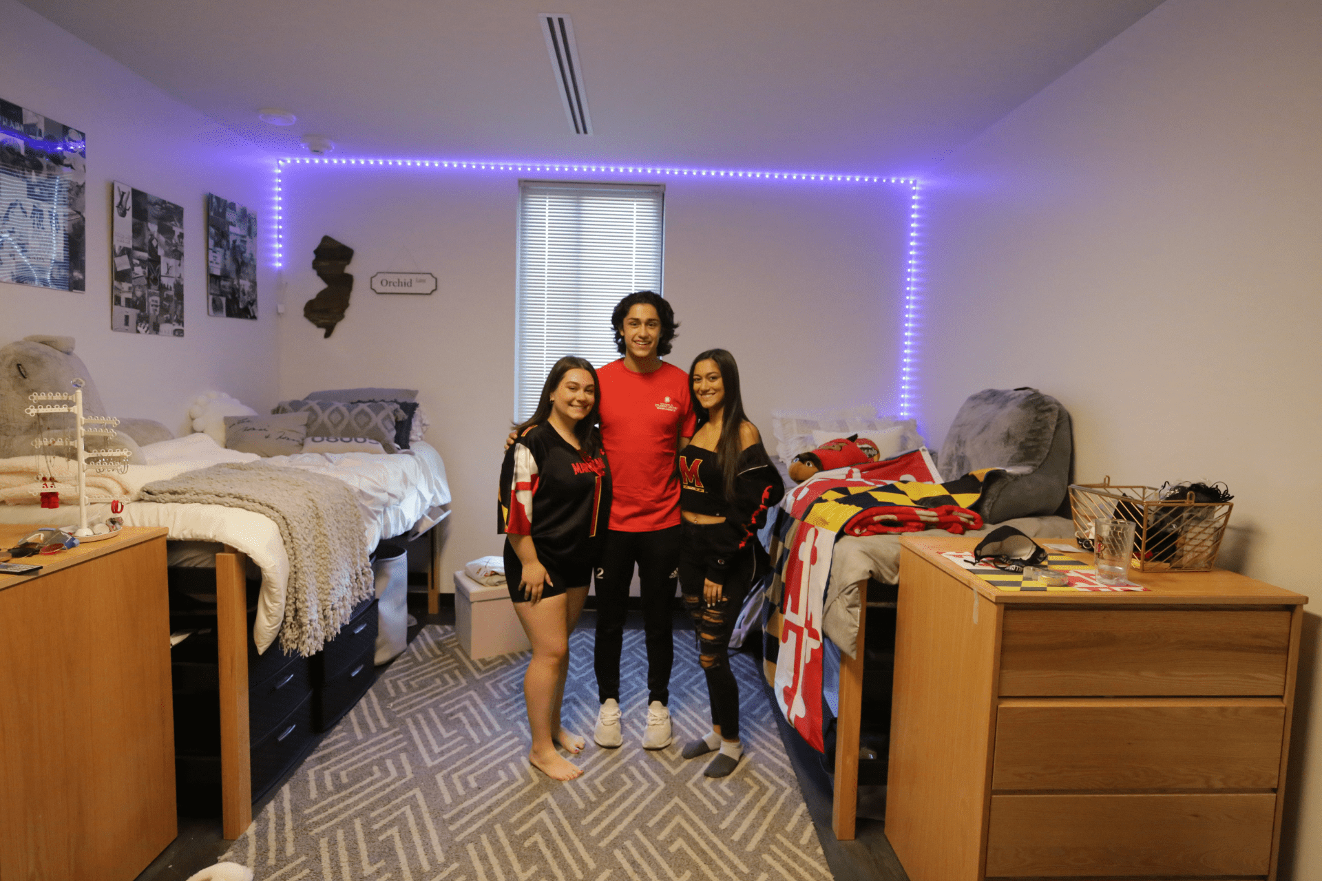 three students in a residence hall room