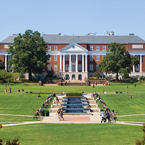 students walking and lounging on McKeldin Mall on a sunny day