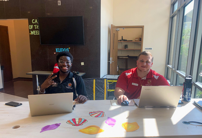 two CAs sitting at front desk of residence hall