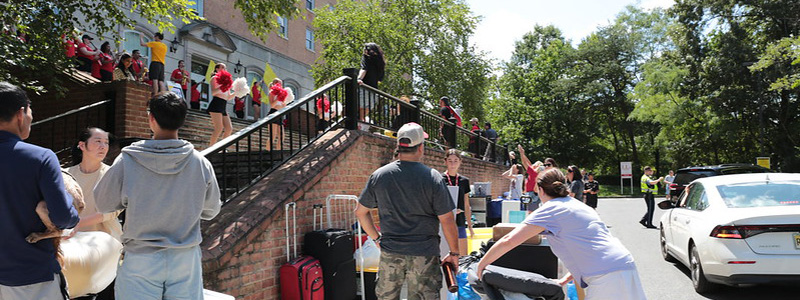 students and families curbside at a residence hall during move-in