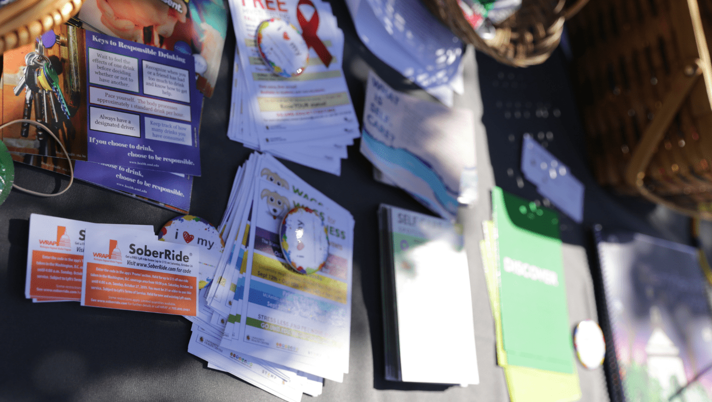 small flyers and buttons on display table at the mental health fair