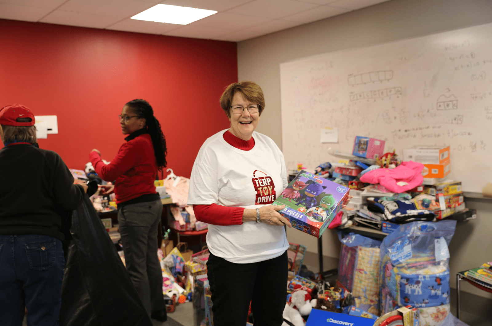 terp toy drive volunteer holding up a toy