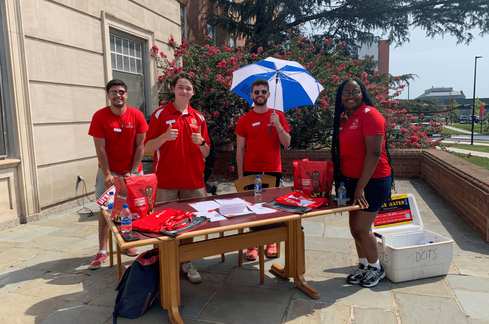 resident assistants at a table outside helping people during move-in