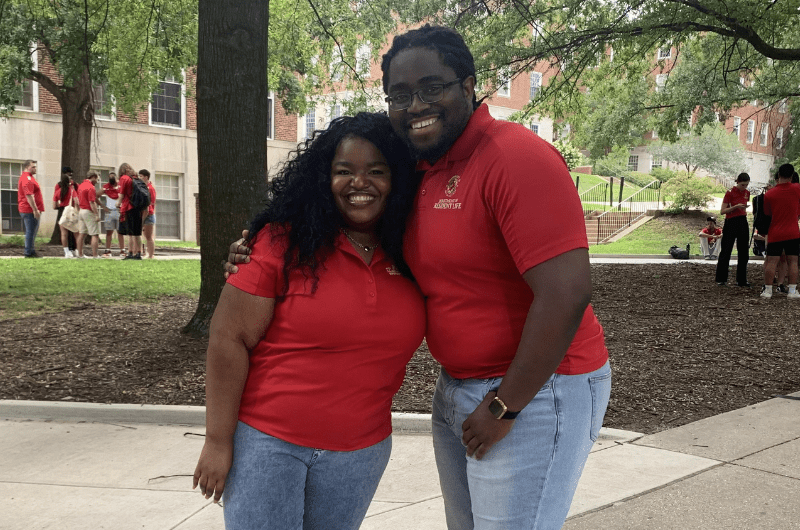 resident directors wearing red shirts posing outside during RA training