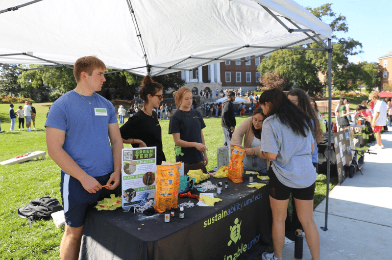 students interacting at the sustainability booth at the self care fair