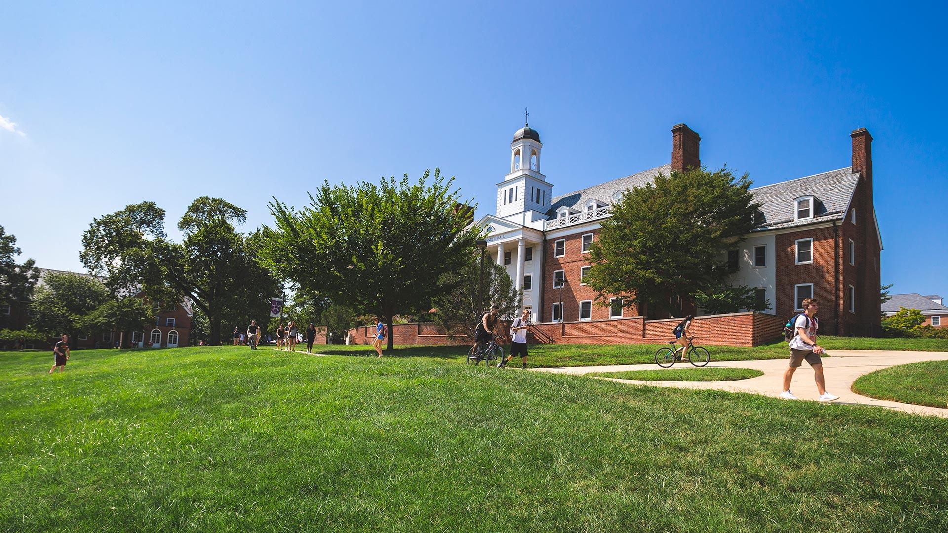 exterior of Anne Arundel Hall with students walking by