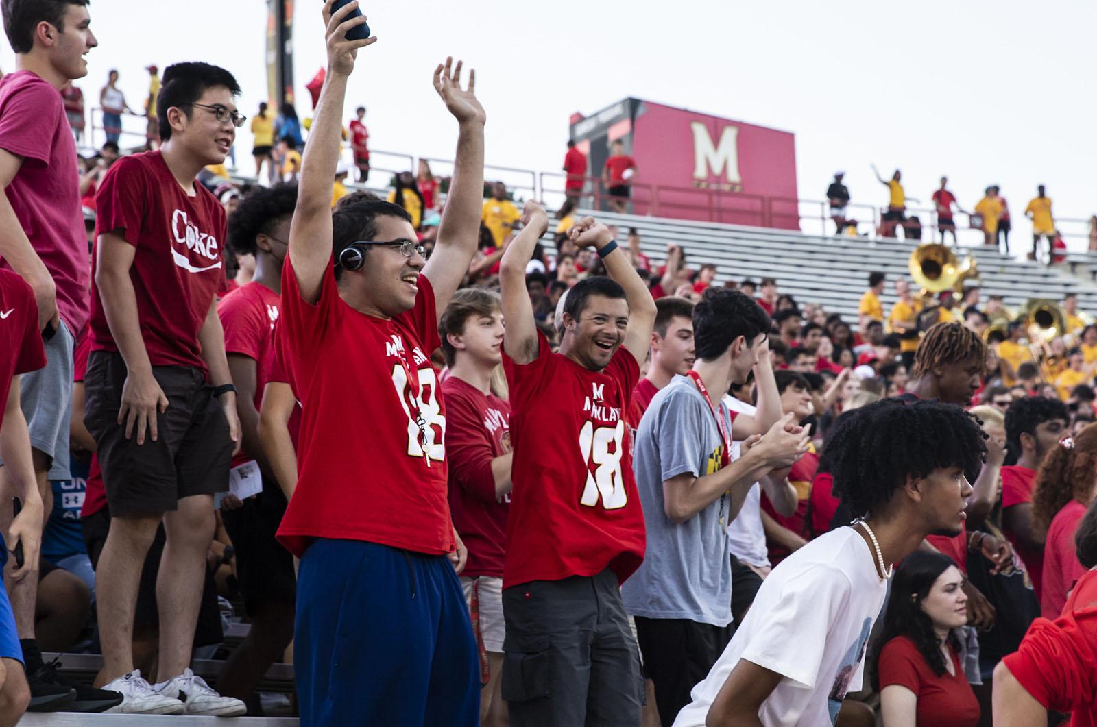 crowd of students with their hands up in the air during the Big Show event