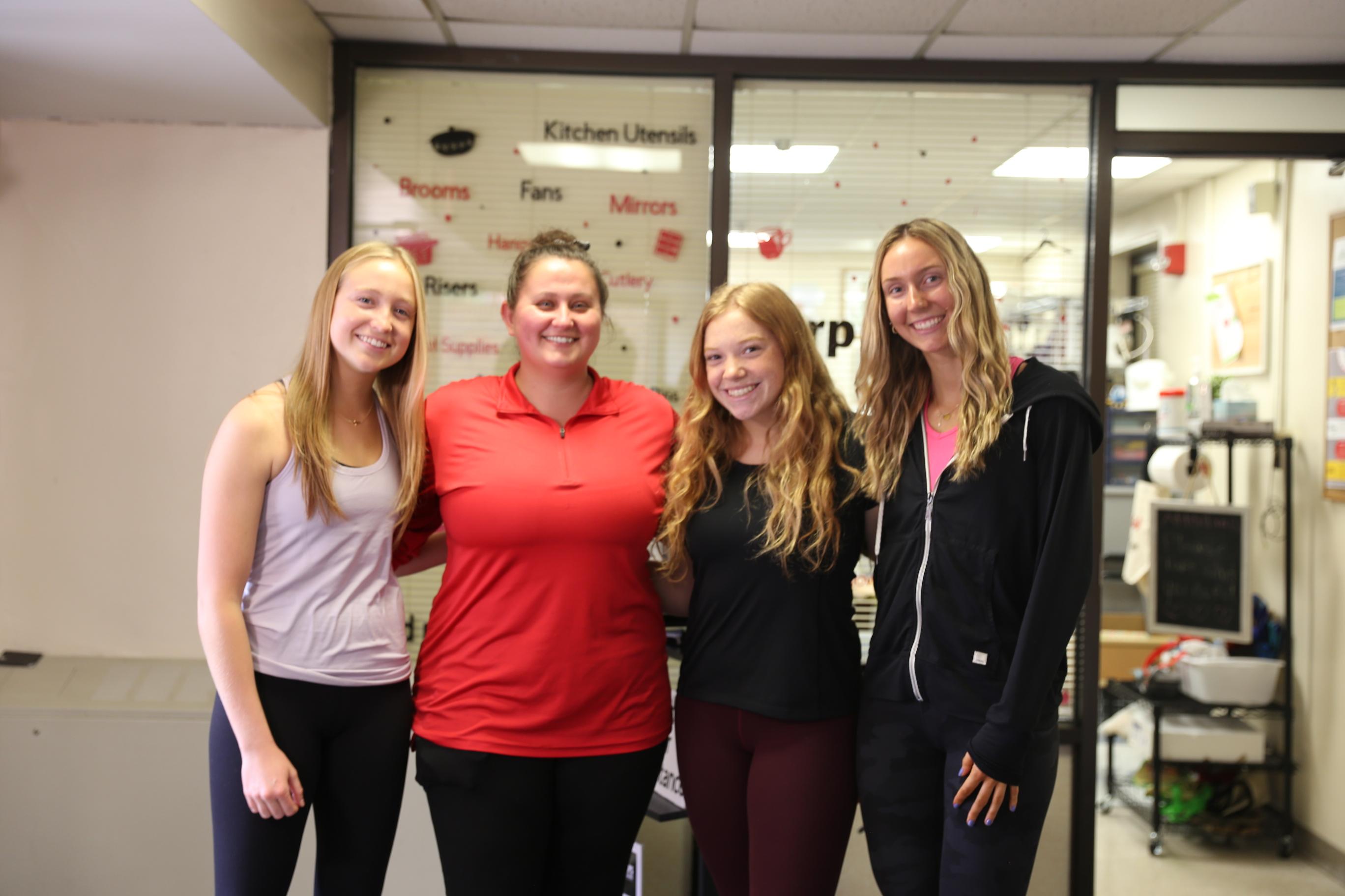 three female students with Lisa Alexander at the Terp to Terp ReUse store
