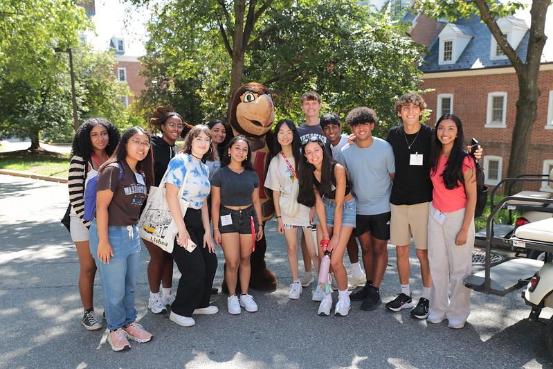 group of students with testudo mascot in front of residence halls on south hill