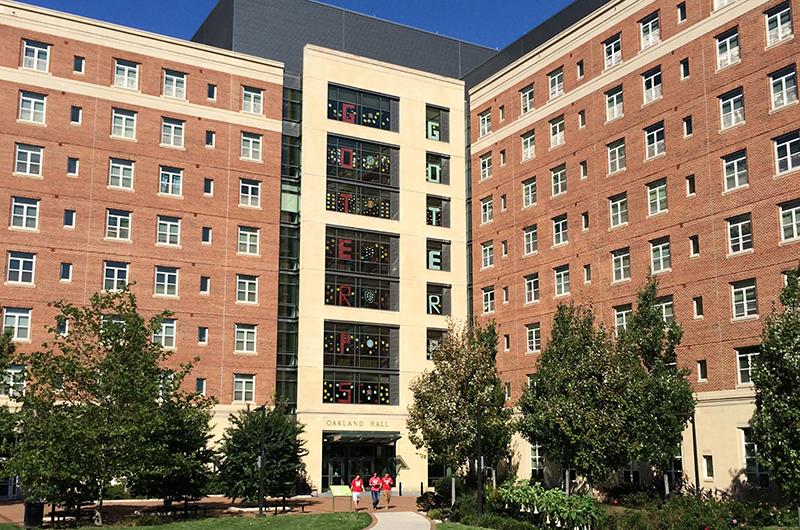 Exterior of Oakland Hall with "GO TERPS" spelled out in the windows.
