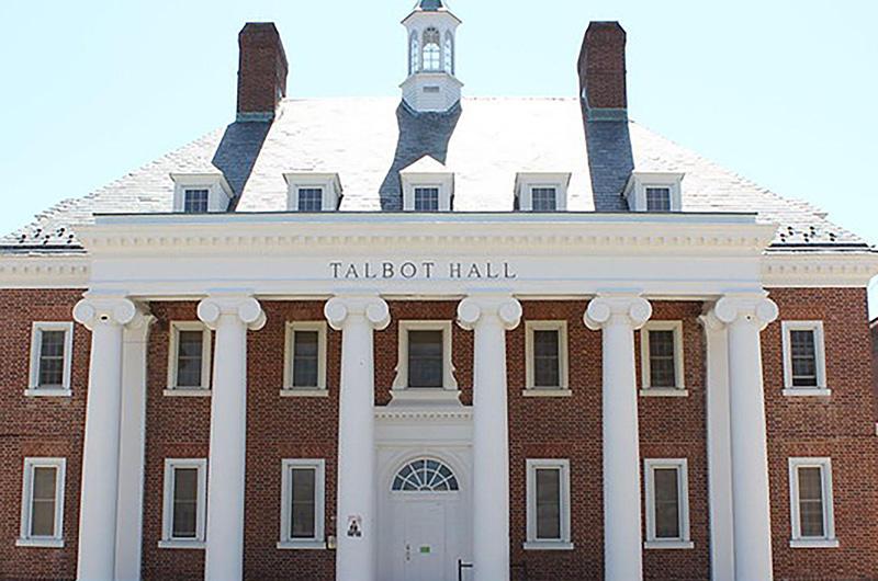 Exterior of Talbot Hall, a brick building with large columns and a small white rooftop cupola.