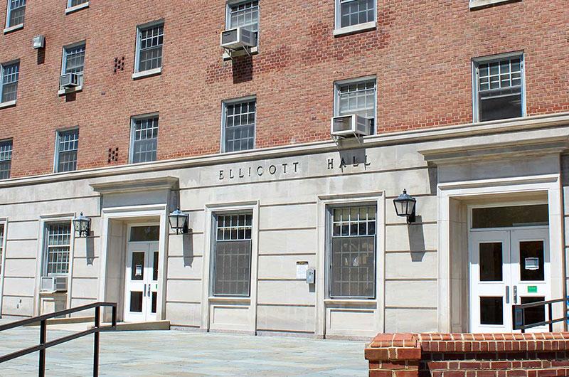Exterior of Ellicott Hall, a multi-story brick building with stone entrances.