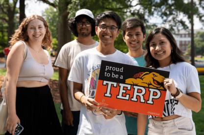 a group of student holding a proud to be a terp sign